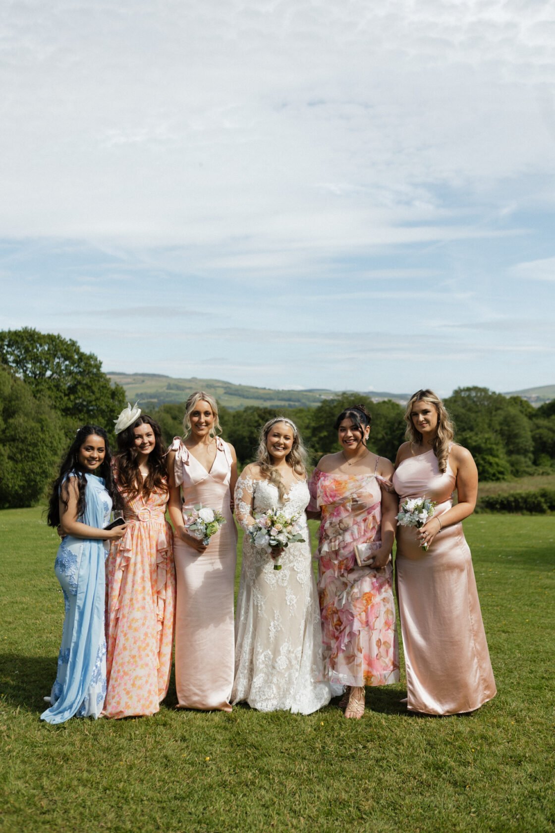 Bride with bridesmaids in a colourful countryside portrait