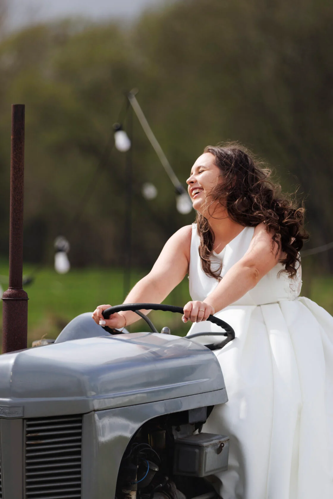 Bride driving tractor