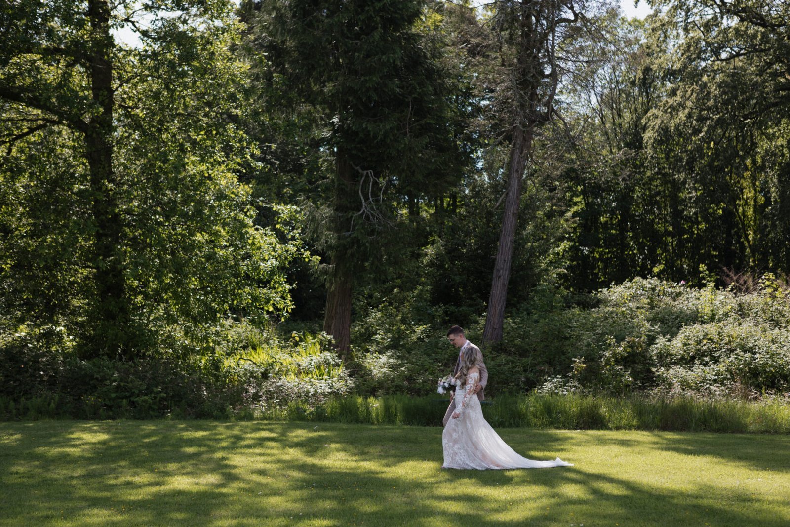 Bride walking woodland garden