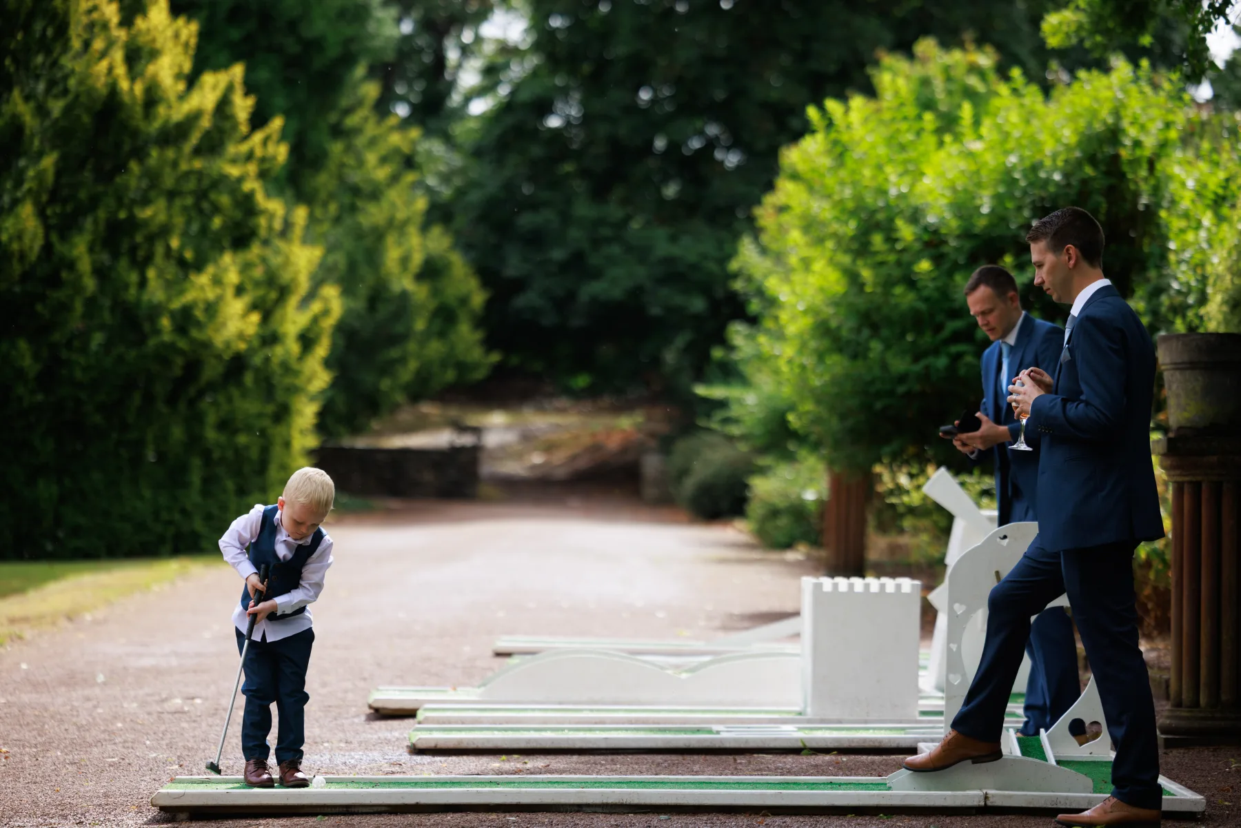 A child playing garden games with wedding guests at Clearwell Castle