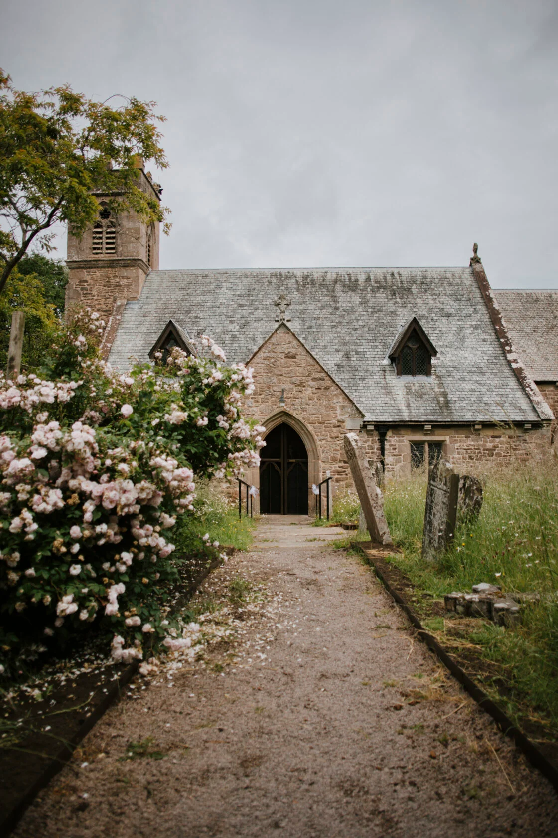 Country church surrounded by roses in Mid Wales
