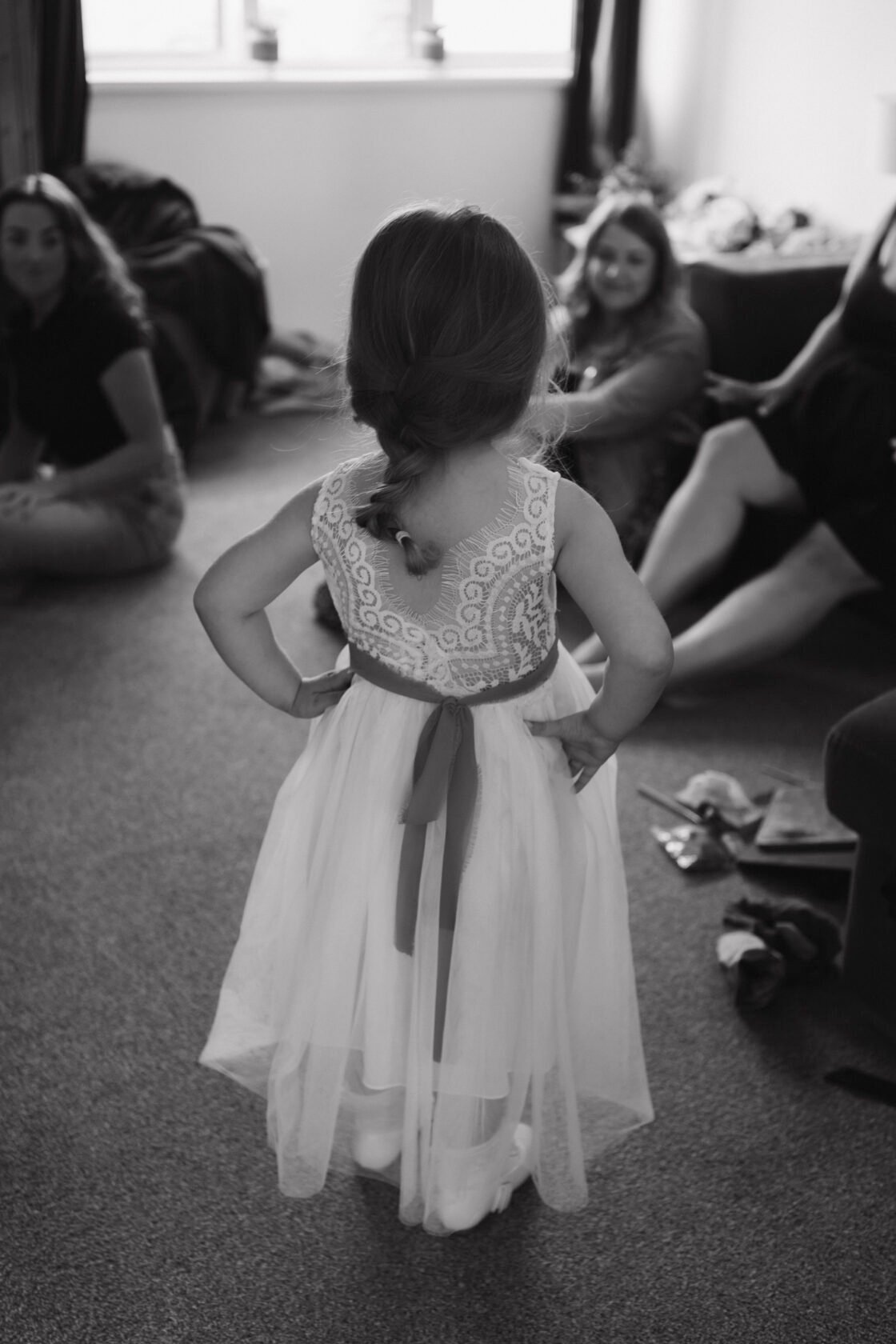 Flower girl getting ready in black and white