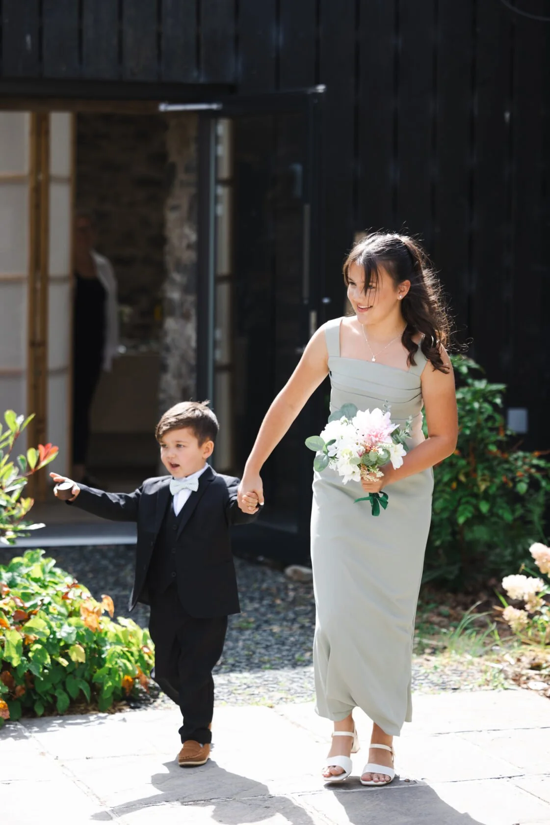 Bride and young page boy arriving for a countryside wedding