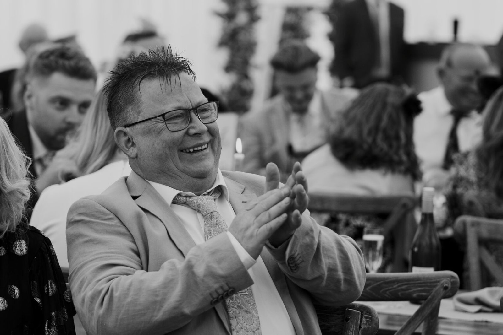 Laughing wedding guest in black and white