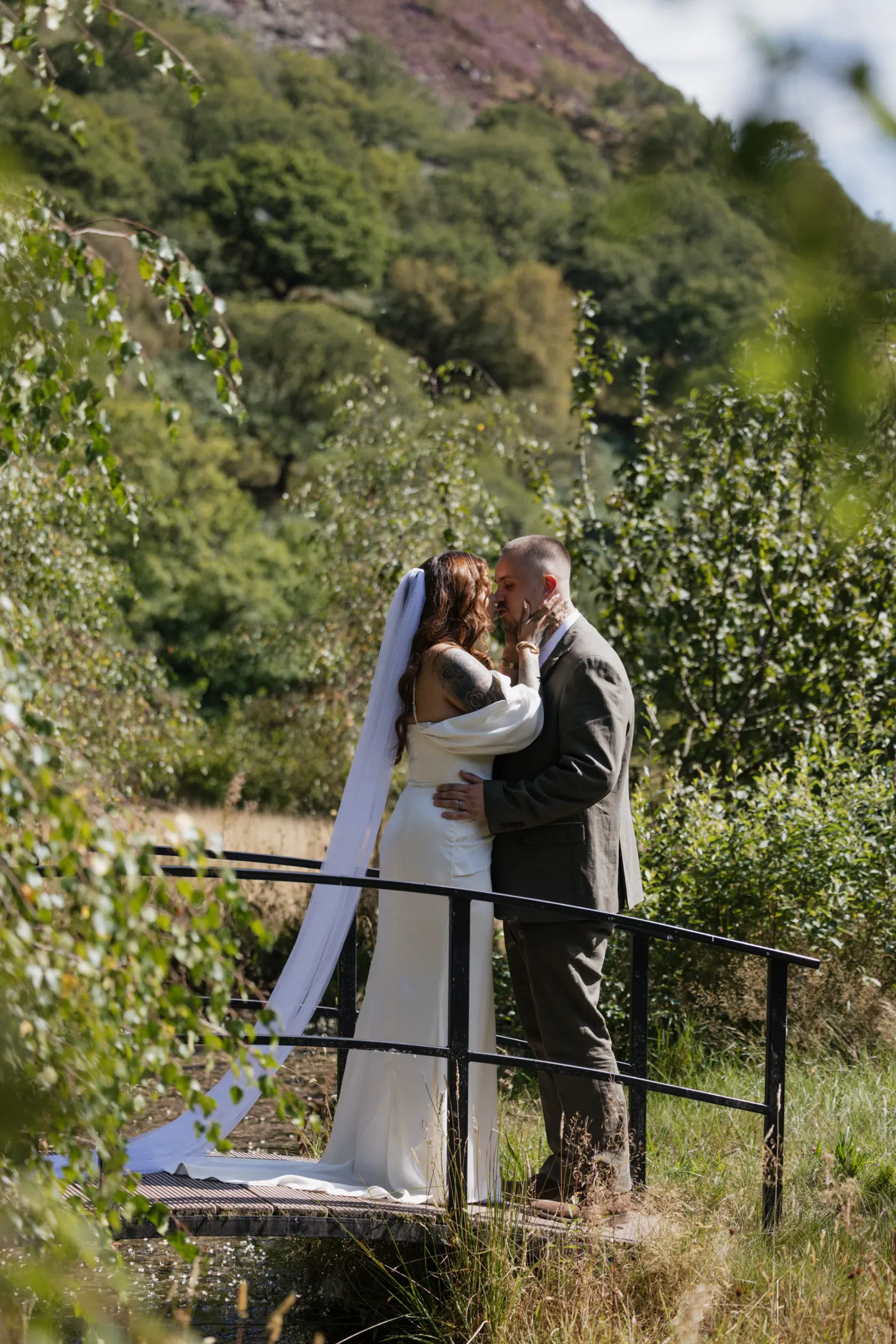 Newlyweds sharing a quiet kiss in the Irfon Valley