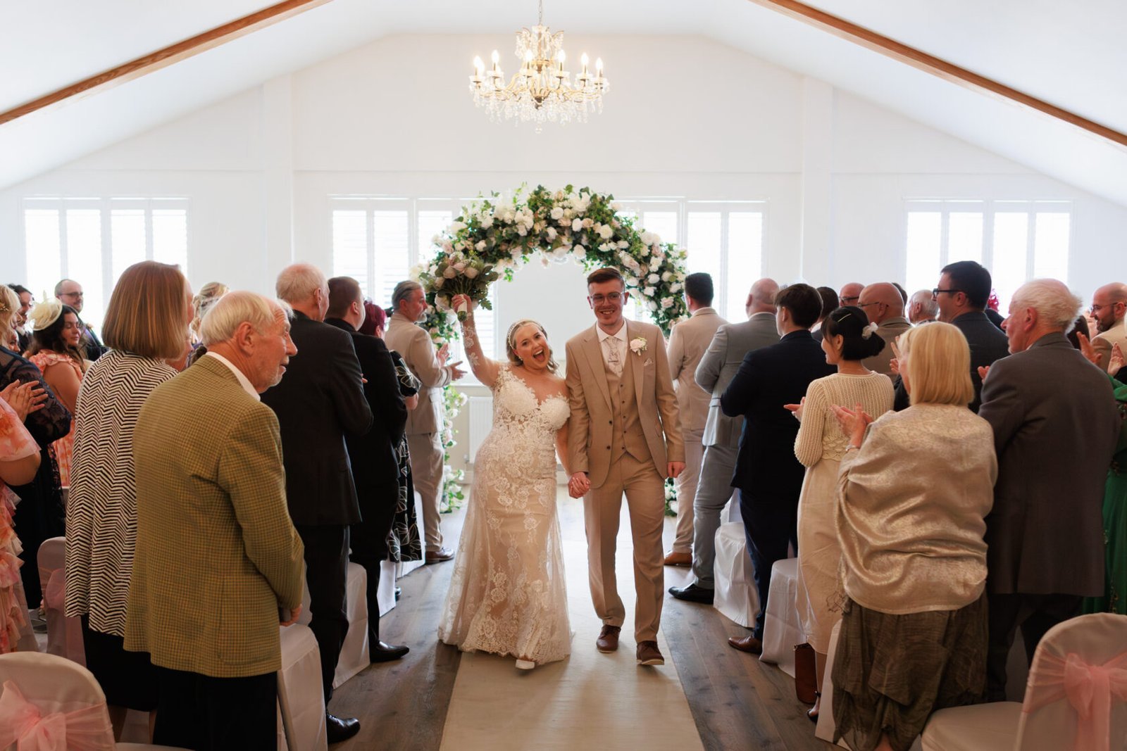 Newlyweds walking ceremony aisle