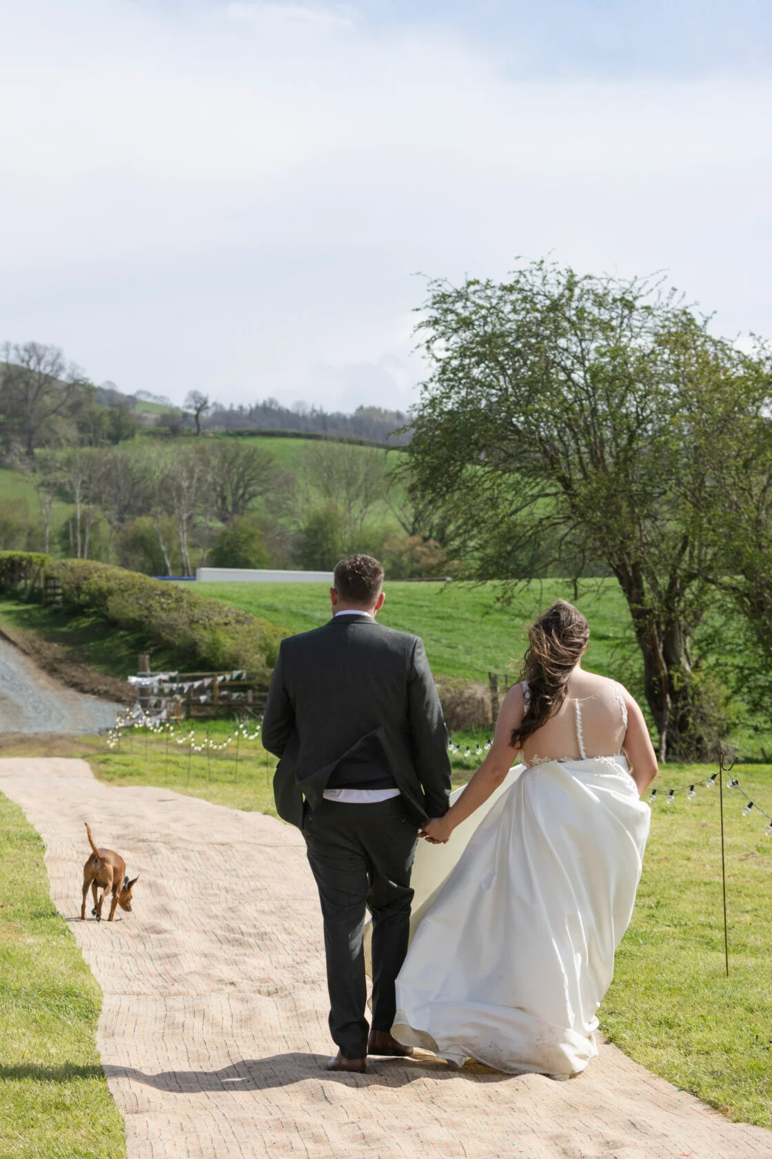 Newlyweds walking country venue